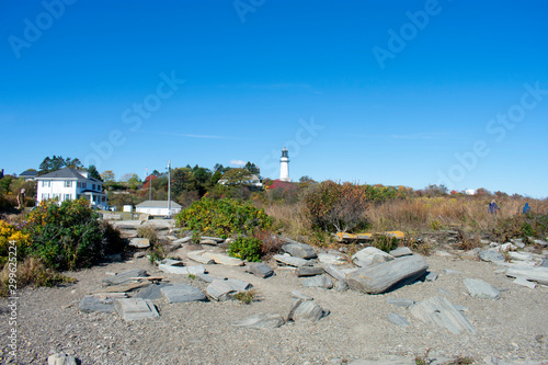 View of Cape Elizabeth Lighthouse from Dyer Point, Cape Elizabeth, Maine. This is a white light tower next to a white building building -05