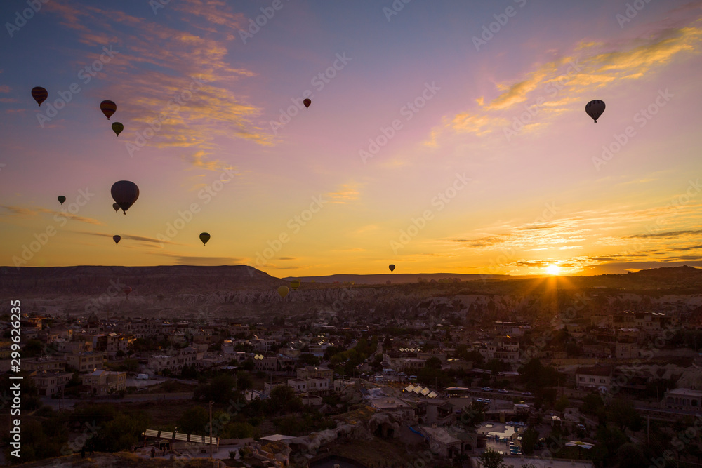 Silhouettes of balloons taking off at sunrise in Cappadocia Turkey 