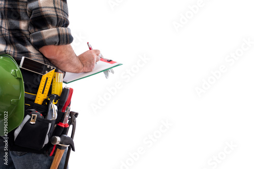 Rear view of a carpenter isolated on white background, writes work notes on a notebook. Work tools industry construction and do it yourself housework. Stock photography.