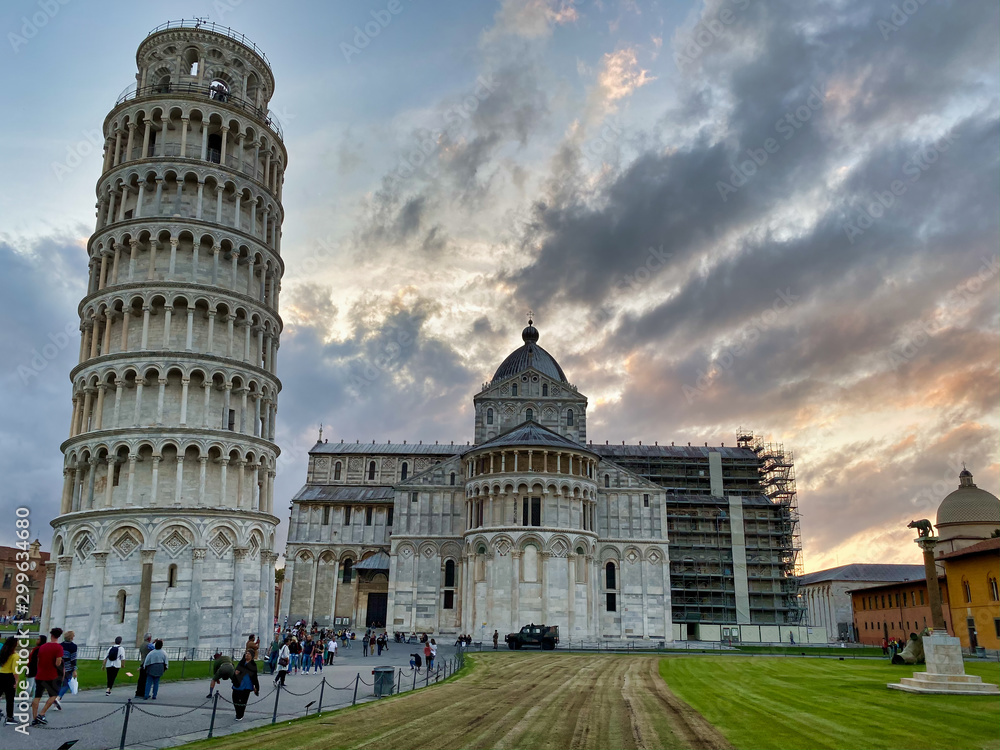PISA, ITALY - SEPTEMBER 27, 2019: Field of Miracles at sunsetwith tourists