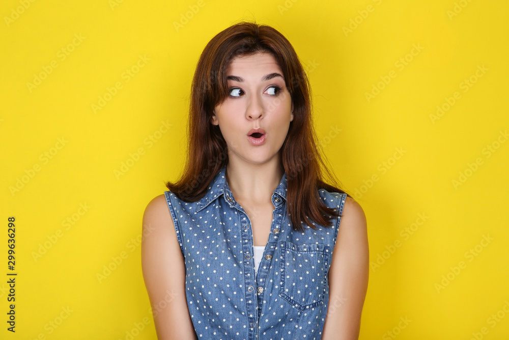 Young woman in stylish clothing on yellow background Young woman in stylish clothing on yellow background