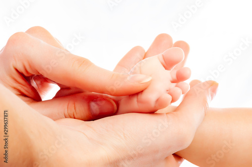 Close-up of caring mother's hands doing massage