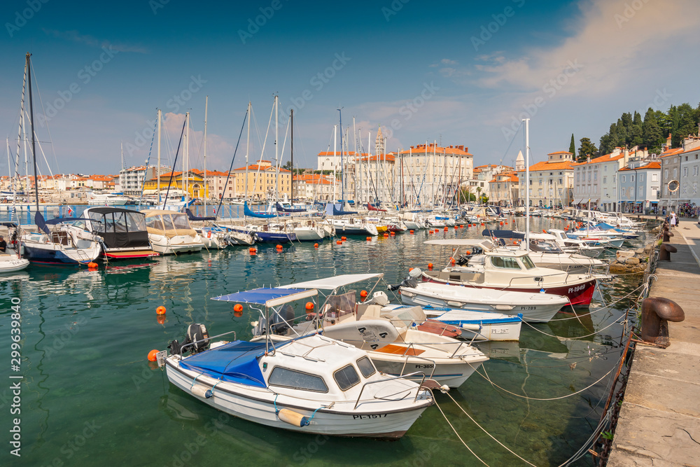Piran marina with fishing boats, sailboats and yachts. Town is situated at the tip of Piran peninsula in Gulf of Piran, Slovenia.