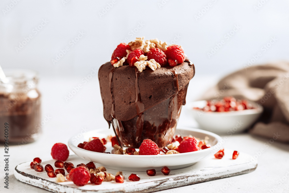 Raspberry mug cake in a glass on light background Raspberry mug cake in a glass on light background