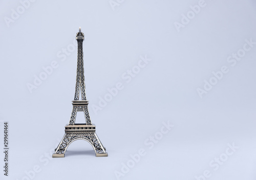 Model of Eiffel Tower on a grey background.