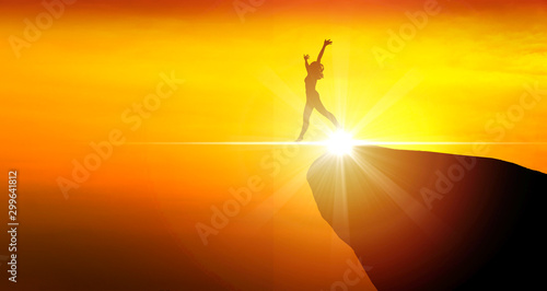 Silhouette of happy woman jumping on a mountain top with rays of light. Shadows slim sports woman raised arms while jump on mountain feeling freedom on the future. Concept of emotions and feelings.