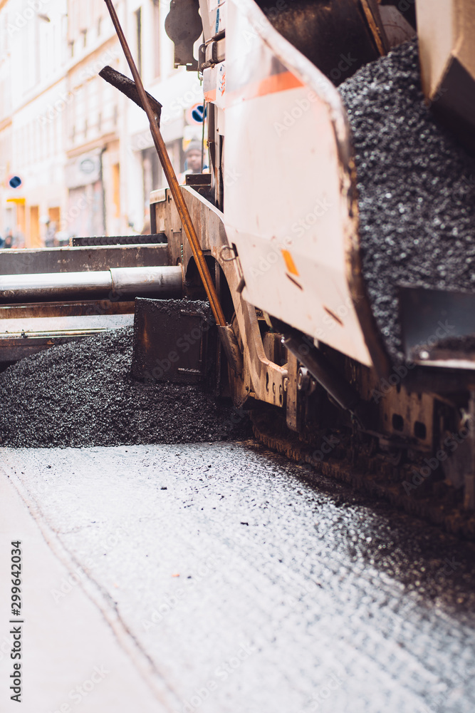 Automatic paving of asphalt on the road - pavement repair Automatic paving of asphalt on the road - pavement repair