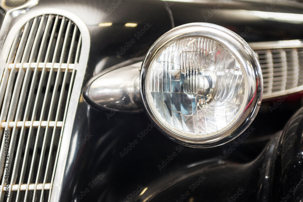 Headlight lamp vintage car. Headlight lamp vintage classic car. Front part with the headlight retro car closeup