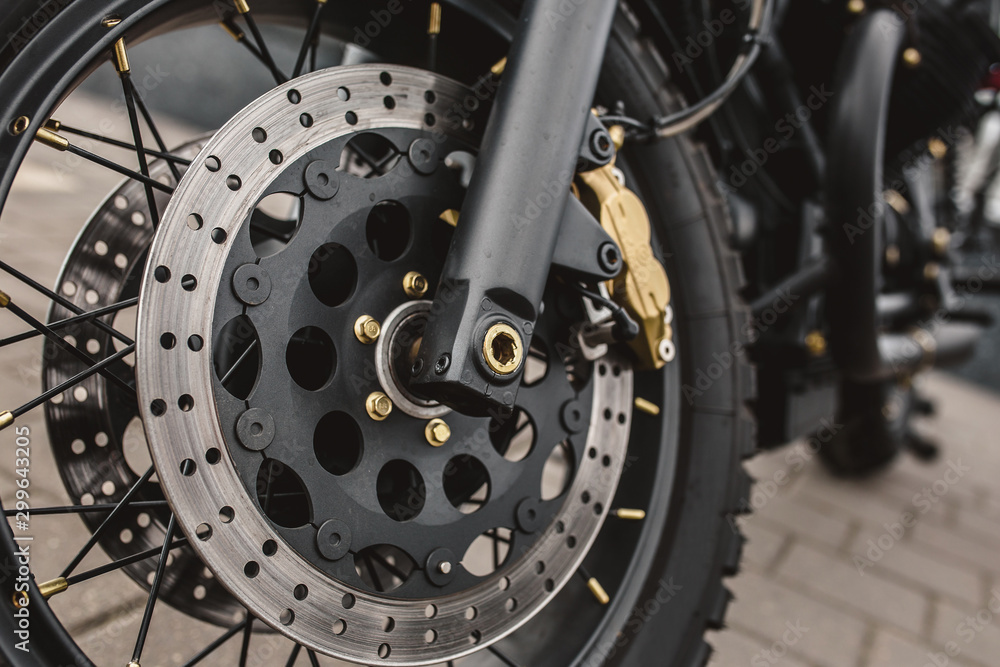 Closeup detail of a powerful vintage motorcycle - front suspension and wheel with brake system