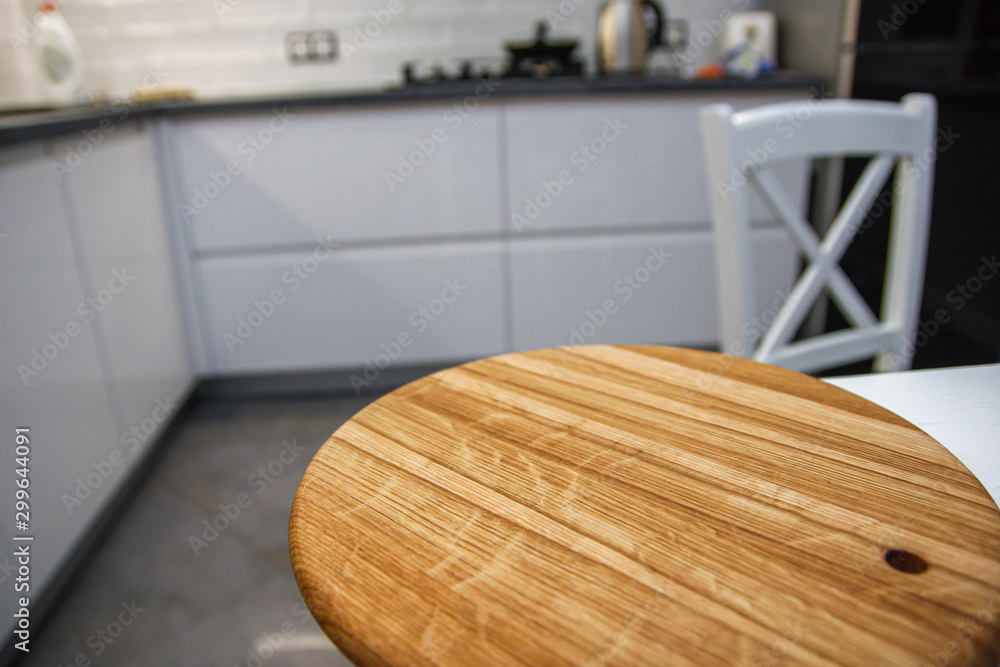 wooden board and blurred kitchen background. place for your item.