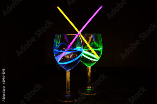 Fresh transparent tropical liquor cocktal in wine glass with dark background for party celebration, new year, bar and christmas with straw decor photo