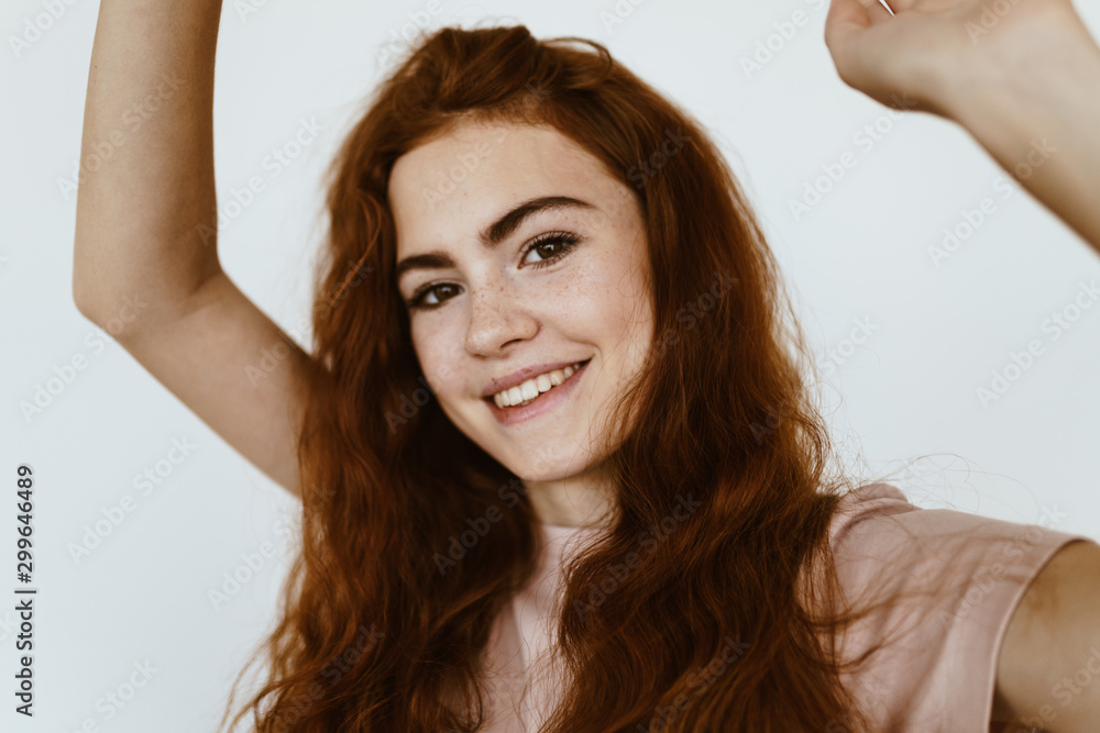 Fototapeta premium schoolgirl in the studio laughing and waving