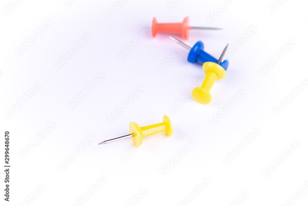 four colored push pins on white background. four colored push pins on white background.