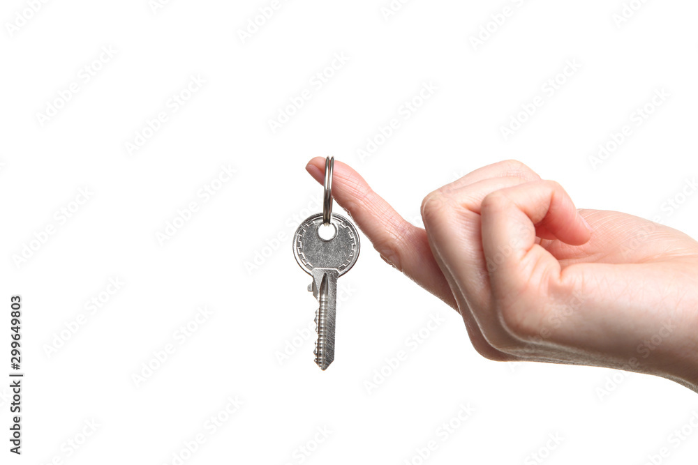 Female hand holding house key on white background Female hand holding house key on white background