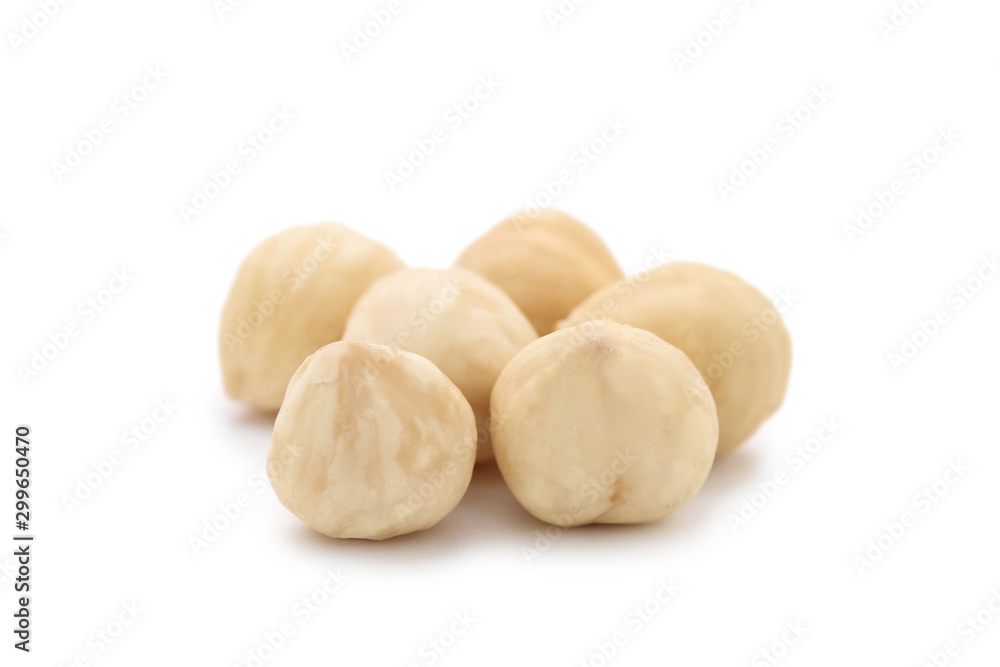 Peeled hazelnuts on isolated white background