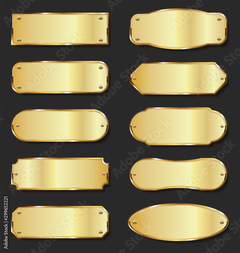 Golden metal plates collection on black background