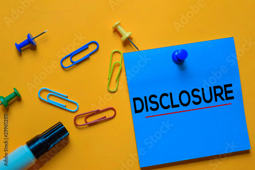 Fotografie Disclosure text on sticky notes. Office desk background.