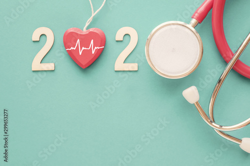 2020 wooden number with red stethoscope. Happy New Year for heart health and medical concept, life insurance business