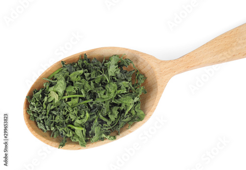 Wooden spoon with dried parsley on white background, top view