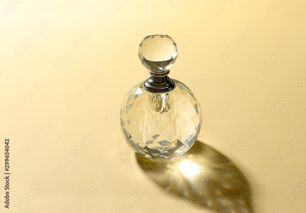 Elegant bottle of perfume on beige background Elegant bottle of perfume on beige background