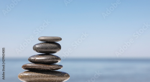 Stack of stones against blurred seascape  space for text. Zen concept