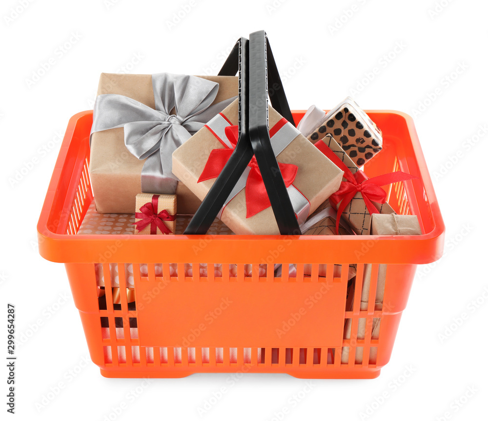 Fototapeta premium Orange shopping basket with different gifts on white background