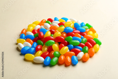 Pile of colorful jelly beans on beige background