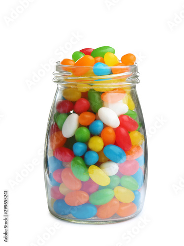 Glass jar of tasty jelly beans on white background