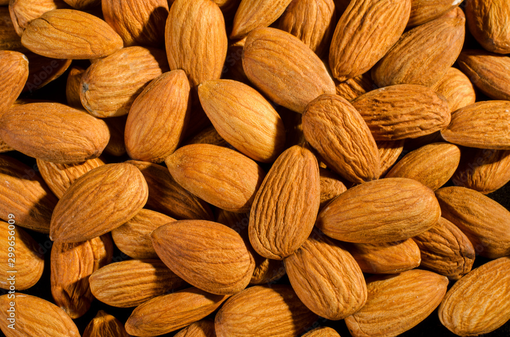 many fresh and roasted almonds many fresh and roasted almonds