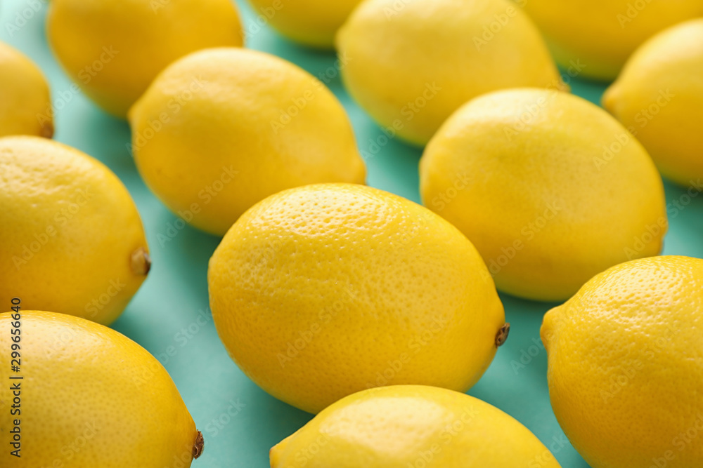 Many fresh lemons on turquoise background, closeup Many fresh lemons on turquoise background, closeup