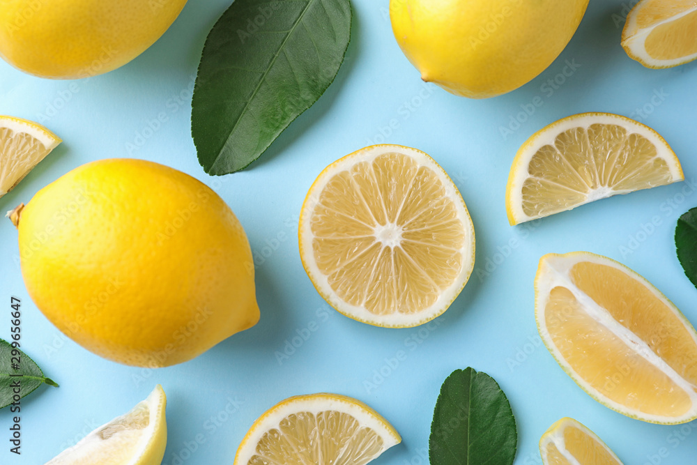 Flat lay composition with fresh lemons on light blue background Flat lay composition with fresh lemons on light blue background