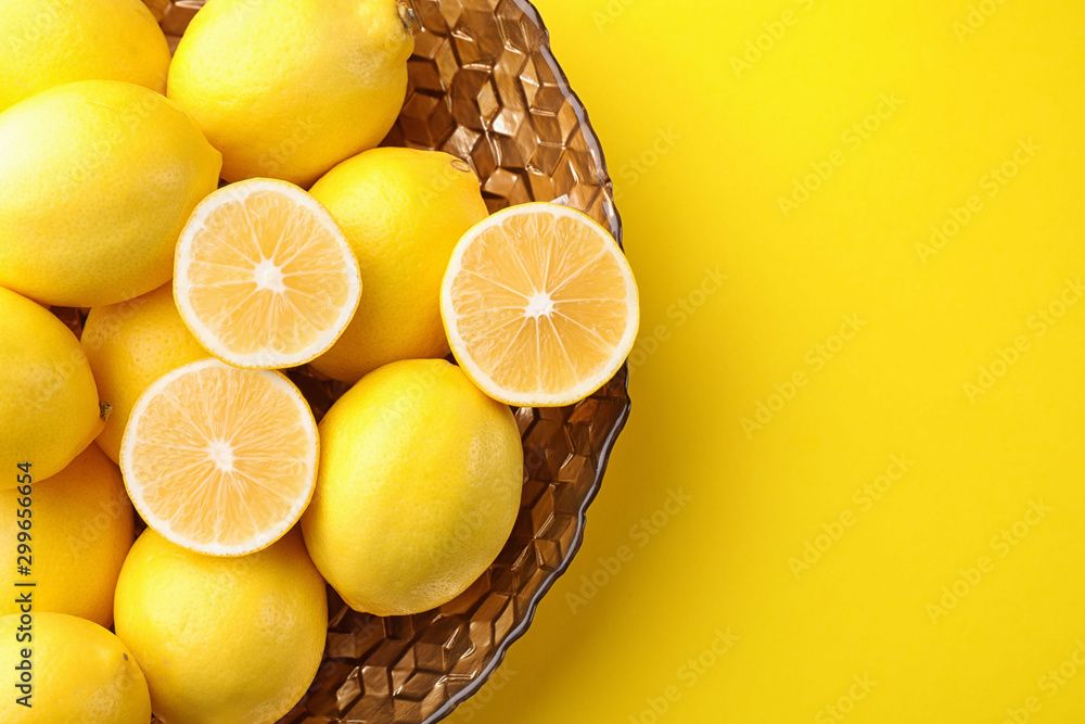 Fresh lemons on yellow background, top view. Space for text - obrazy, fototapety, plakaty 