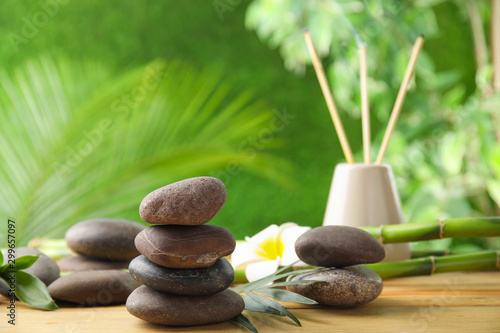 Composition with stones on table against blurred background. Zen concept