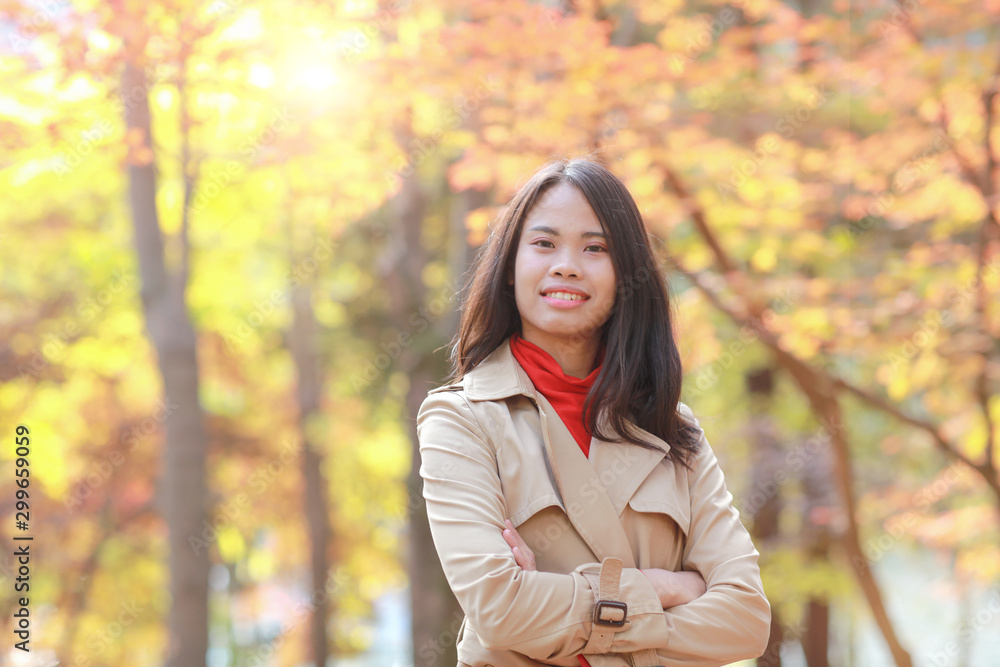 young woman in autumn park at Nami island South Korea young woman in autumn park at Nami island South Korea