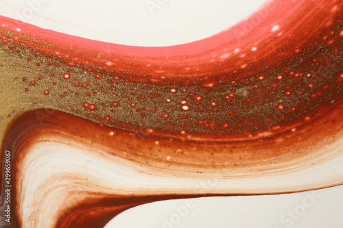Abstract background in pastel pink, chocolate brown, metallic gold, and white that resembles stretched, curving taffy. photo