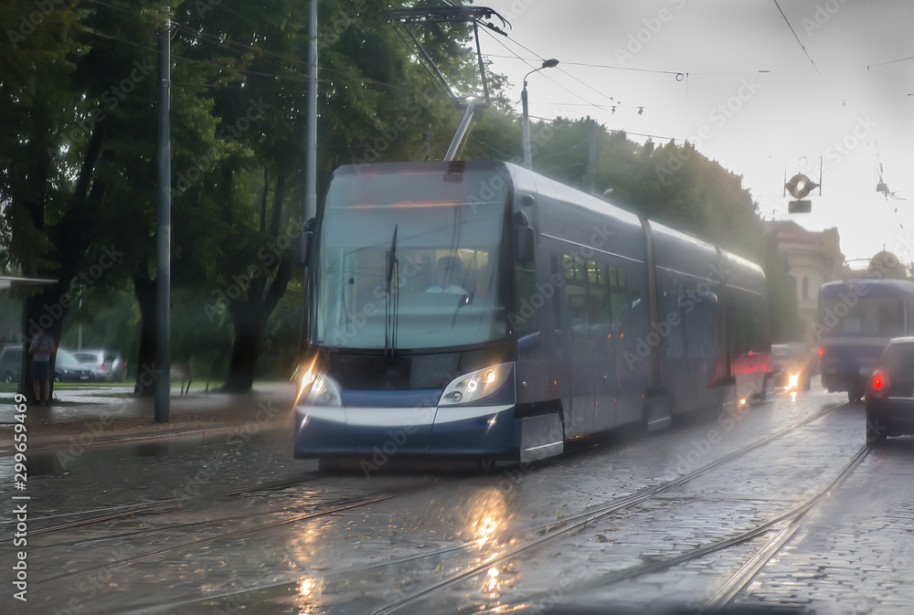 Fototapeta premium modern tram moves along a city street