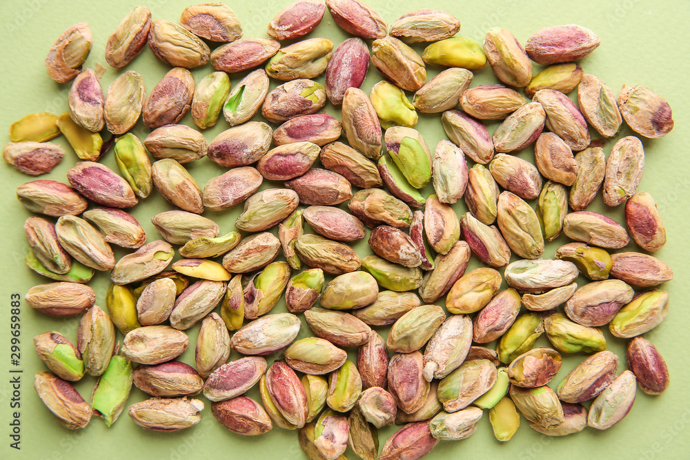 Tasty pistachio nuts on color background Tasty pistachio nuts on color background