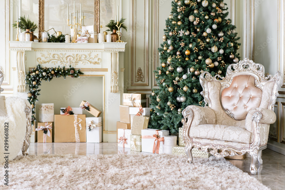 Christmas morning. Classic luxurious apartments with decorated christmas tree and presents. Living with fireplace, columns and stucco.