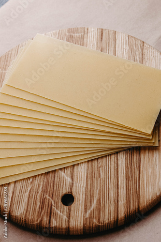 Lasagna sheets, durum wheat pasta on a wooden surface.