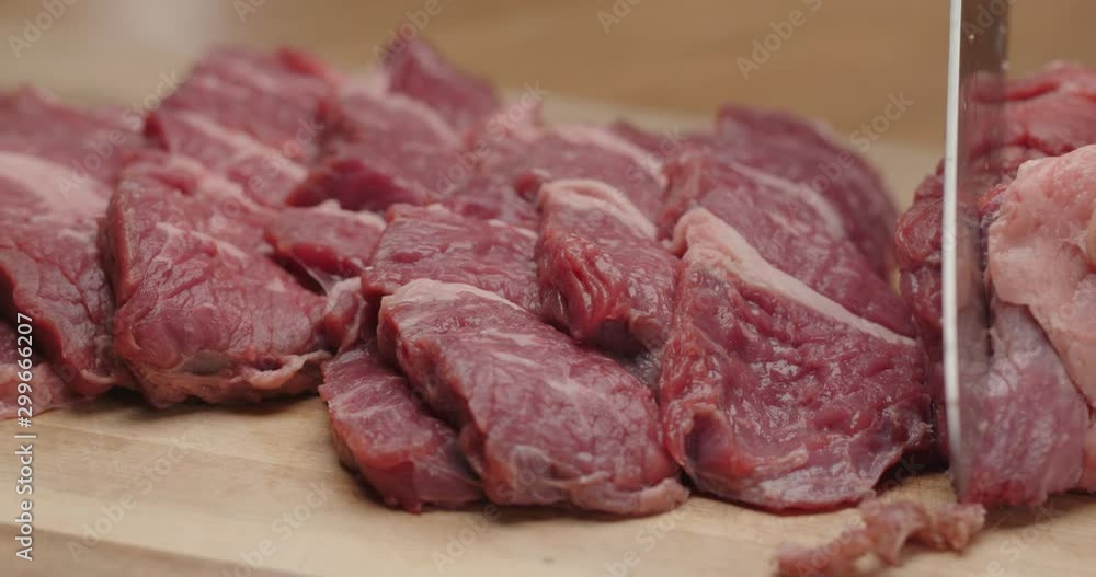 Close up of cutting beef with chef knife, marinate meat, macro shot of cooking process, dramatic look, preparing a dinner, slow motion, red epic Close up of cutting beef with chef knife, marinate meat, macro shot of cooking process, dramatic look, preparing a dinner, slow motion, red epic