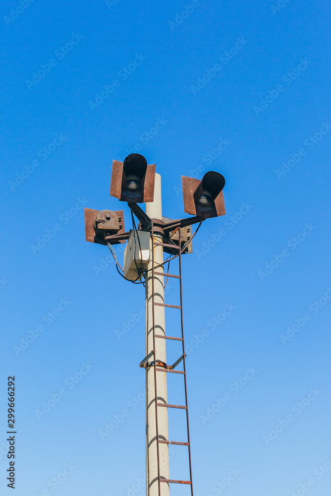 Rusty railroad lights and blue sky outdoors Rusty railroad lights and blue sky outdoors
