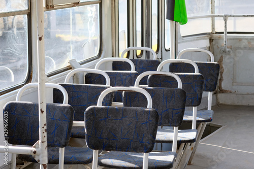 Seats in the old tram. Empty lounge of an old city transport. Public transport with soft seats.