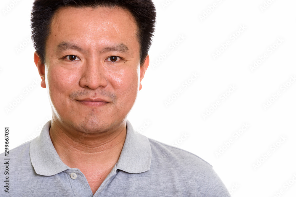 Studio shot of Japanese man isolated against white background Studio shot of Japanese man isolated against white background