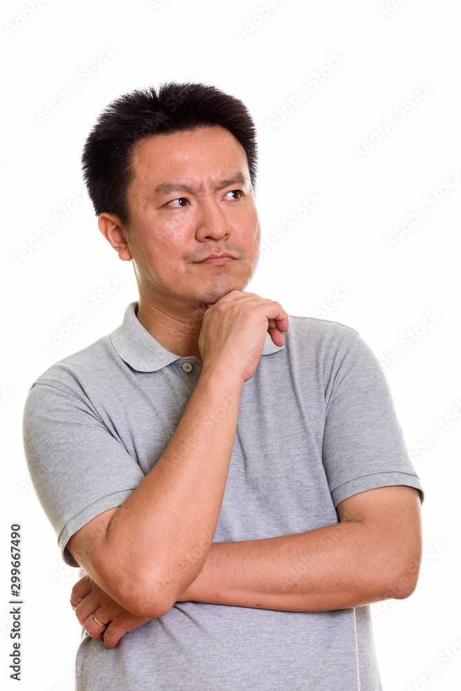 Studio shot of Japanese man isolated against white background Studio shot of Japanese man isolated against white background