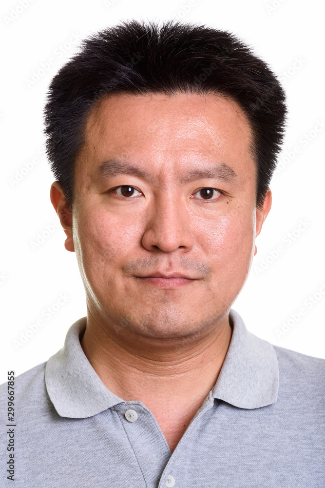 Studio shot of Japanese man isolated against white background Studio shot of Japanese man isolated against white background