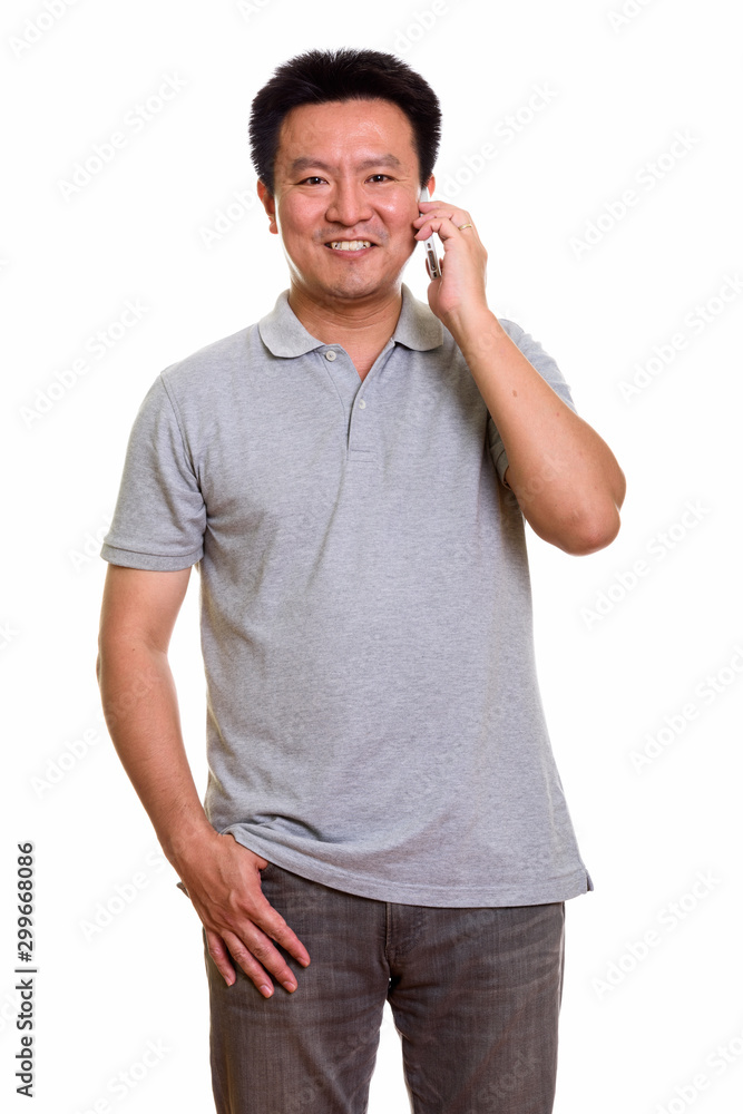 Studio shot of Japanese man isolated against white background Studio shot of Japanese man isolated against white background