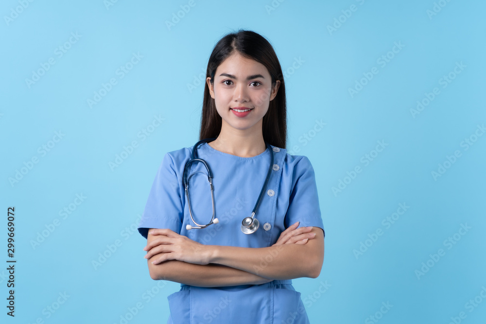 Young woman in nurse uniform smile isolated on light blue background. Young woman in nurse uniform smile isolated on light blue background.