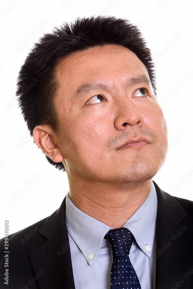 Studio shot of Japanese man isolated against white background Studio shot of Japanese man isolated against white background