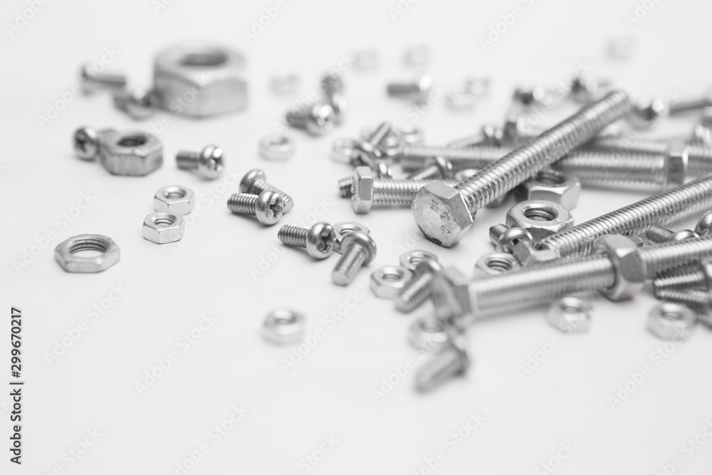 Selective focus of Many nuts and bolts on white background Selective focus of Many nuts and bolts on white background