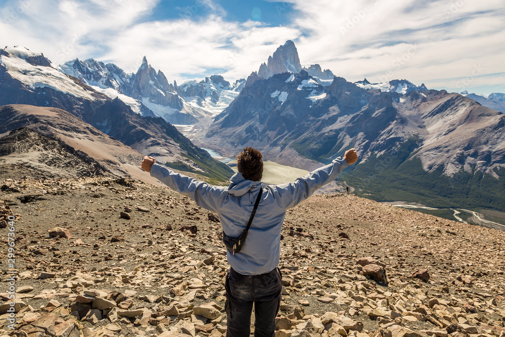 Positive man standing with arms outstretched at the top of the mountain. Positive man standing with arms outstretched at the top of the mountain.